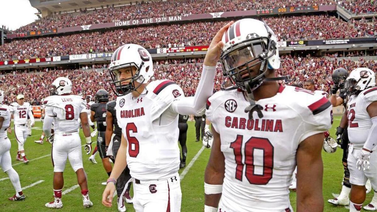 South Carolina quarterback Connor Mitch consoles linebacker Skai Moore (10) after their loss to Texas A&M at Kyle Field in College Station, Texas, Saturday, October 31, 2015.