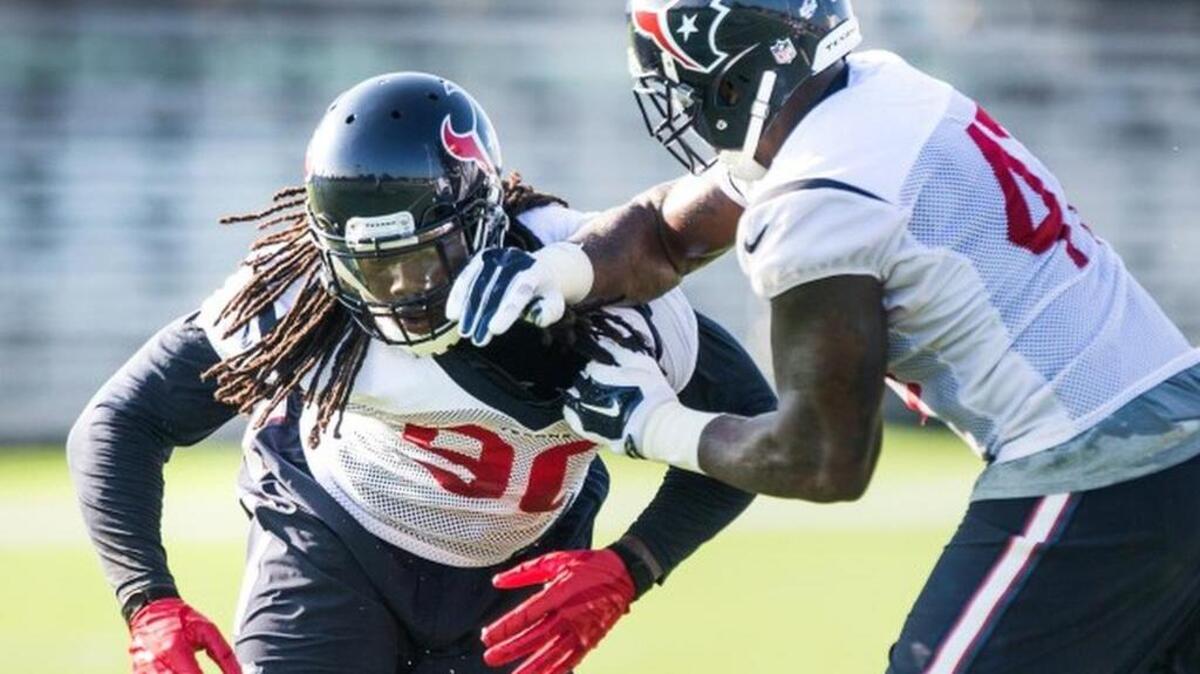 
Houston Texans linebacker Jadeveon Clowney (90) and Lynden Trail (47) run a drill during the Texans NFL football training camp Monday, Aug. 17, 2015, in Houston. Clowney returned to practice on a limited basis for the first time since microfracture knee surgery in December. 
