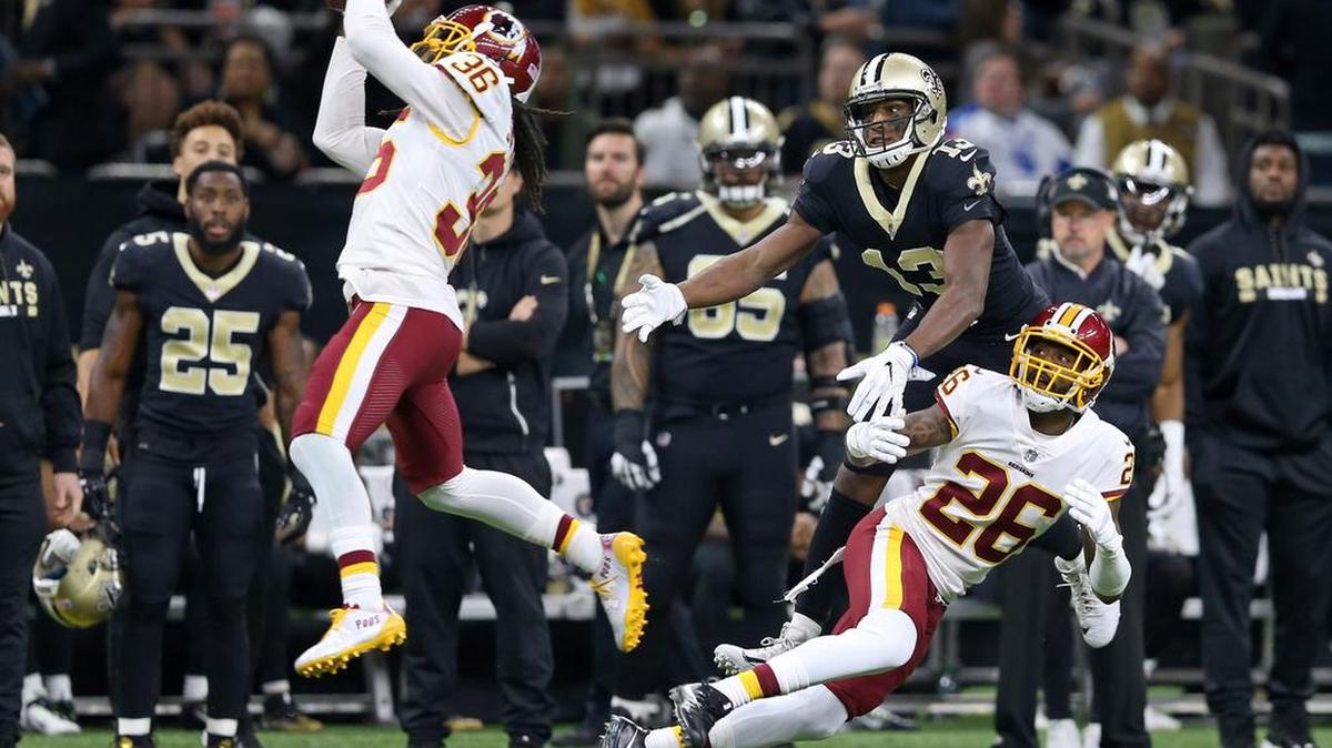 Washington Redskins safety D.J. Swearinger (36) intercepts a pass intended for New Orleans Saints wide receiver Michael Thomas (13) as Redskins cornerback Bashaud Breeland (26) defends in the first quarter at the Mercedes-Benz Superdome.