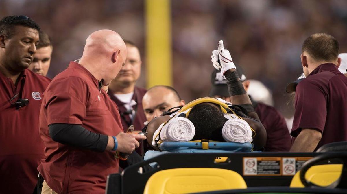 South Carolina wide receiver Terry Googer (6) gives a thumbs up to the crowd as he is carted off the field during the first quarter against the Texas A&M Aggies.