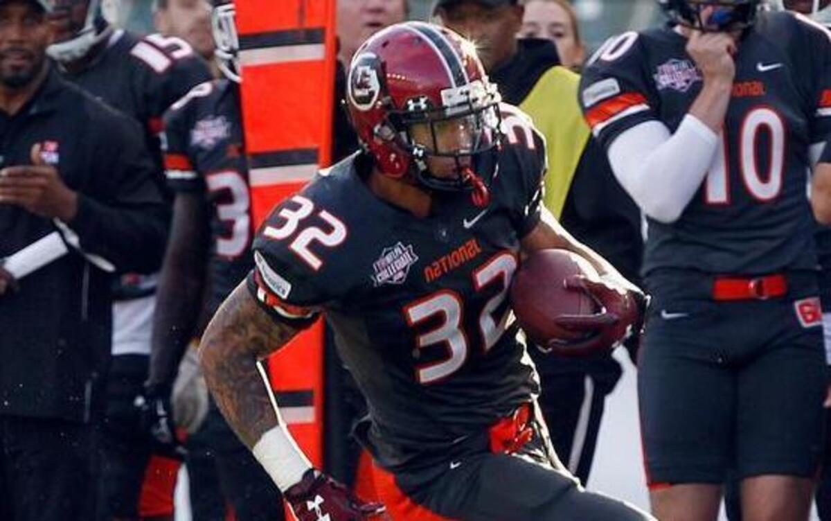 National team running back Brandon Wilds, right, of South Carolina, runs during the NFLPA Collegiate Bowl football game in Carson, Calif., on Saturday.