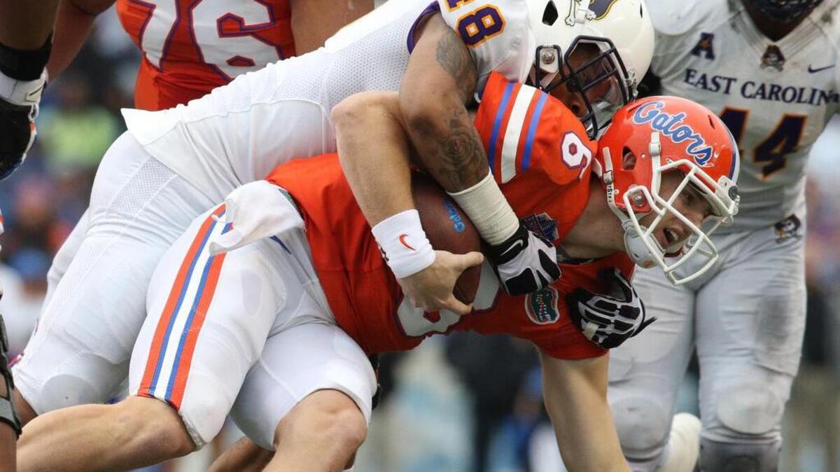 From Jan 3, 2015: Florida quarterback Jeff Driskel (6) is tackled by East Carolina linebacker Maurice Falls (48) in the Birmingham Bowl.