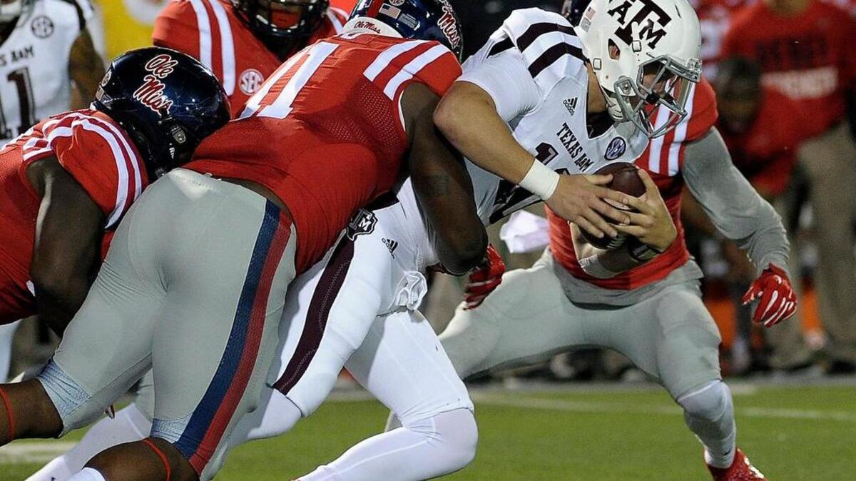 Mississippi Rebels defensive end Channing Ward (11) tackles Texas A&M Aggies quarterback Kyle Allen (10) on Saturday.