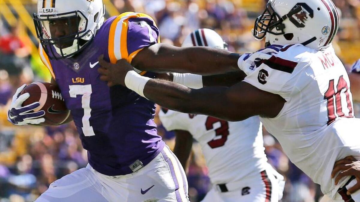 
LSU running back Leonard Fournette (7) stiff arms South Carolina linebacker Skai Moore (10) Saturday during the first half.
