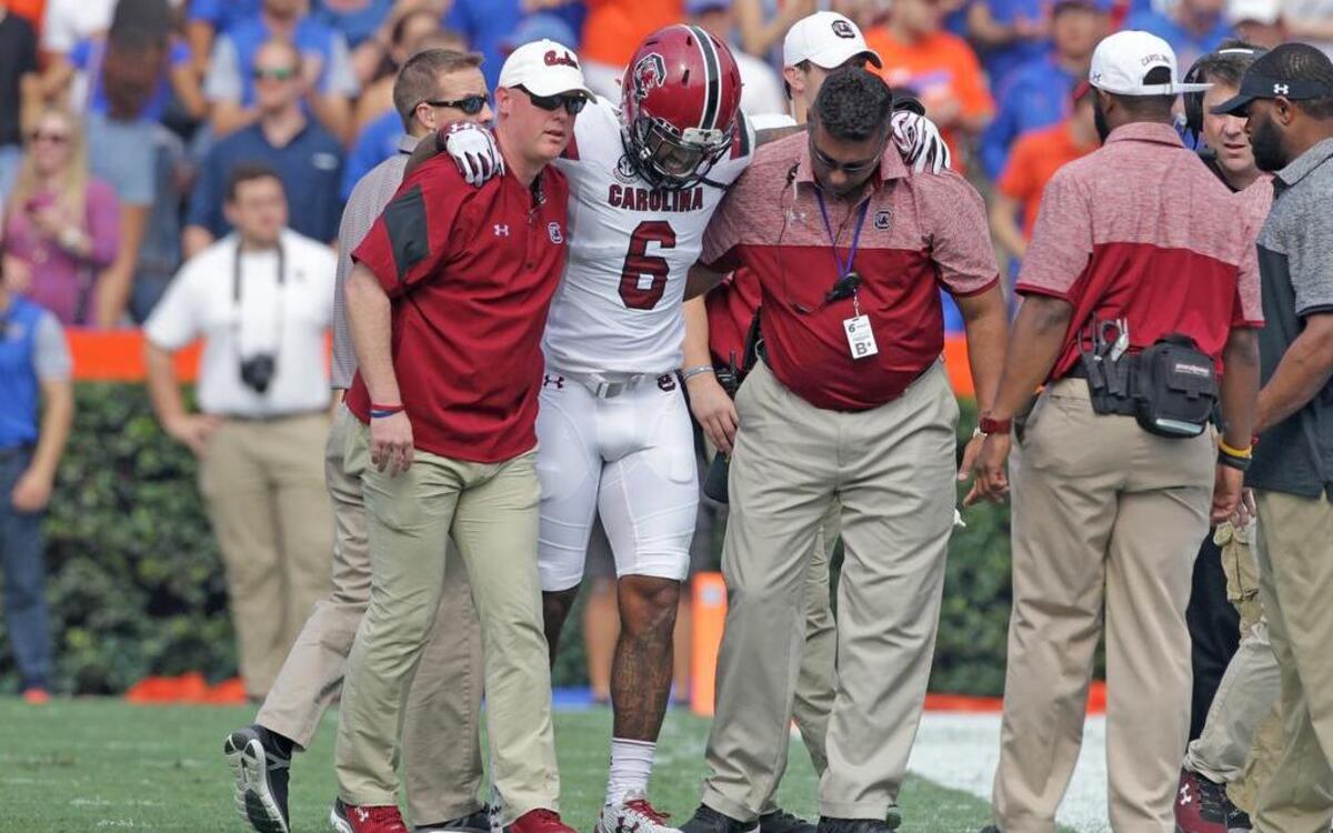 South Carolina Gamecocks defensive back Chris Moody (6) is helped off the field after an injury at Florida.