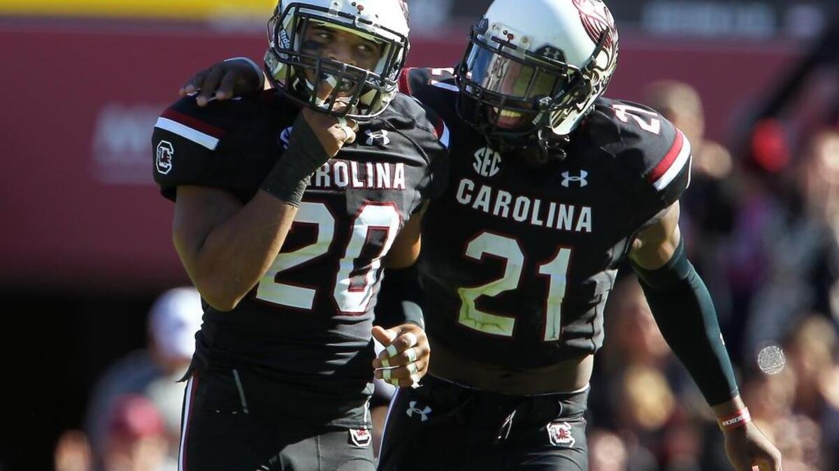 South Carolina’s T.J. Gurley (20) and Isaiah Johnson celebrate Gurley’s interception in the first half against Florida.