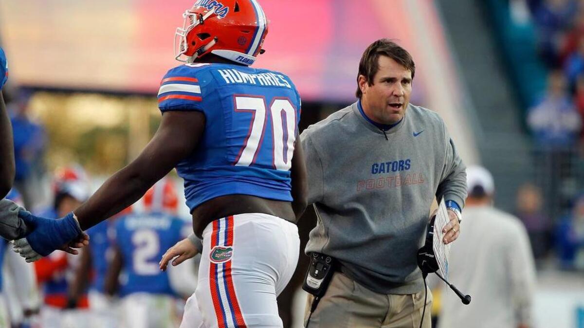 Will Muschamp high fives offensive lineman D.J. Humphries (70), one of the five-star talents he drew to Florida.