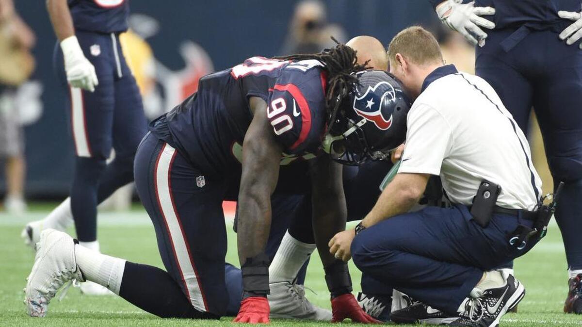 Houston Texans outside linebacker Jadeveon Clowney (90) is attended to after he was injured during the first half of an NFL football game against the Tennessee Titans, Sunday, Nov. 1, 2015, in Houston. (AP Photo/Eric Christian Smith)