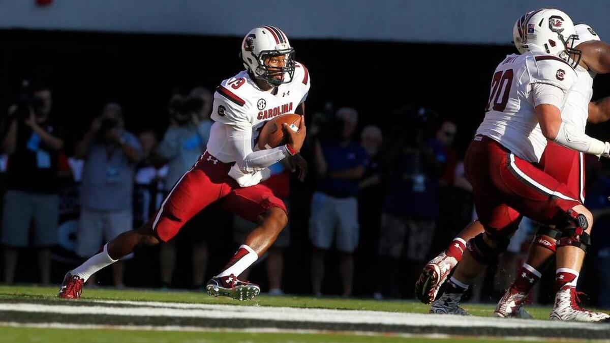 
South Carolina quarterback Lorenzo Nunez (19) keeps the ball against Georgia.
