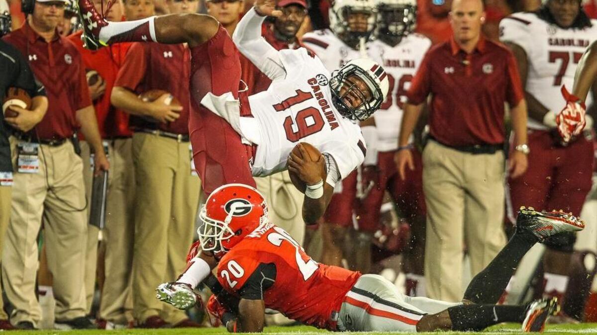
South Carolina quarterback Lorenzo Nunez (19) is brought down by Georgia safety Quincy Mauger during the second half Saturday.

