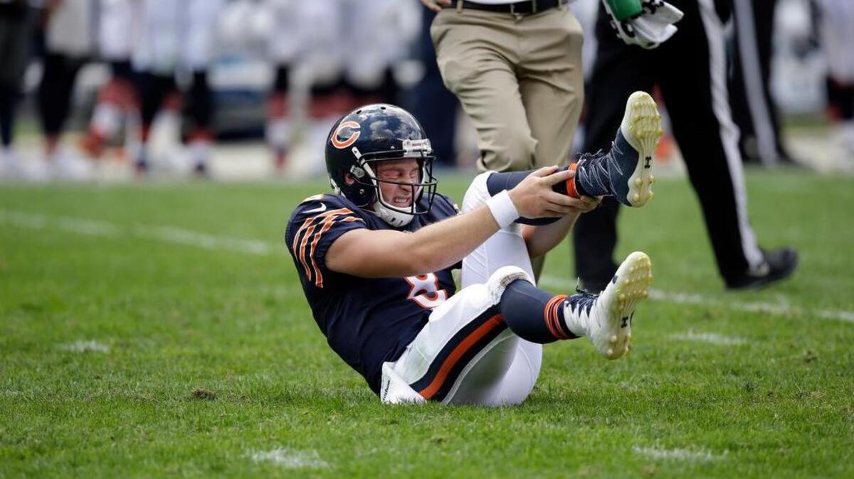 Chicago Bears quarterback Connor Shaw (8) holds his leg after getting hurt on a play during the second half of an NFL preseason football game against the Kansas City Chiefs, Saturday, Aug. 27, 2016, in Chicago. The Chiefs won 23-7.