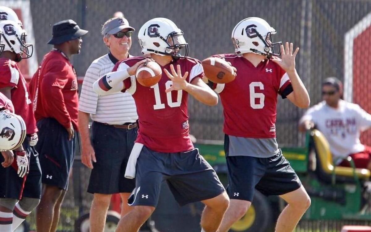 
South Carolina Gamecocks quarterbacks Perry Orth (10) and Connor Mitch (6) go through a drill during another spring football practice.
