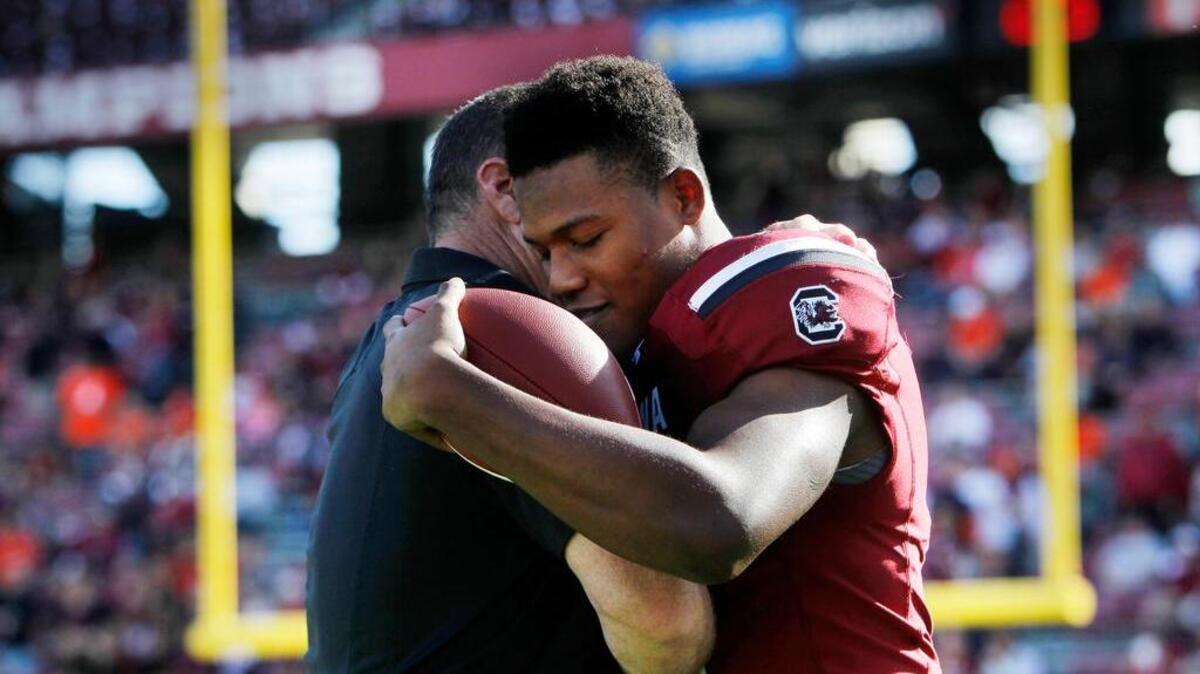 South Carolina Gamecocks wide receiver Pharoh Cooper (11) hugs interim head coach Shawn Elliott as he takes part in senior day at Williams-Brice Stadium.