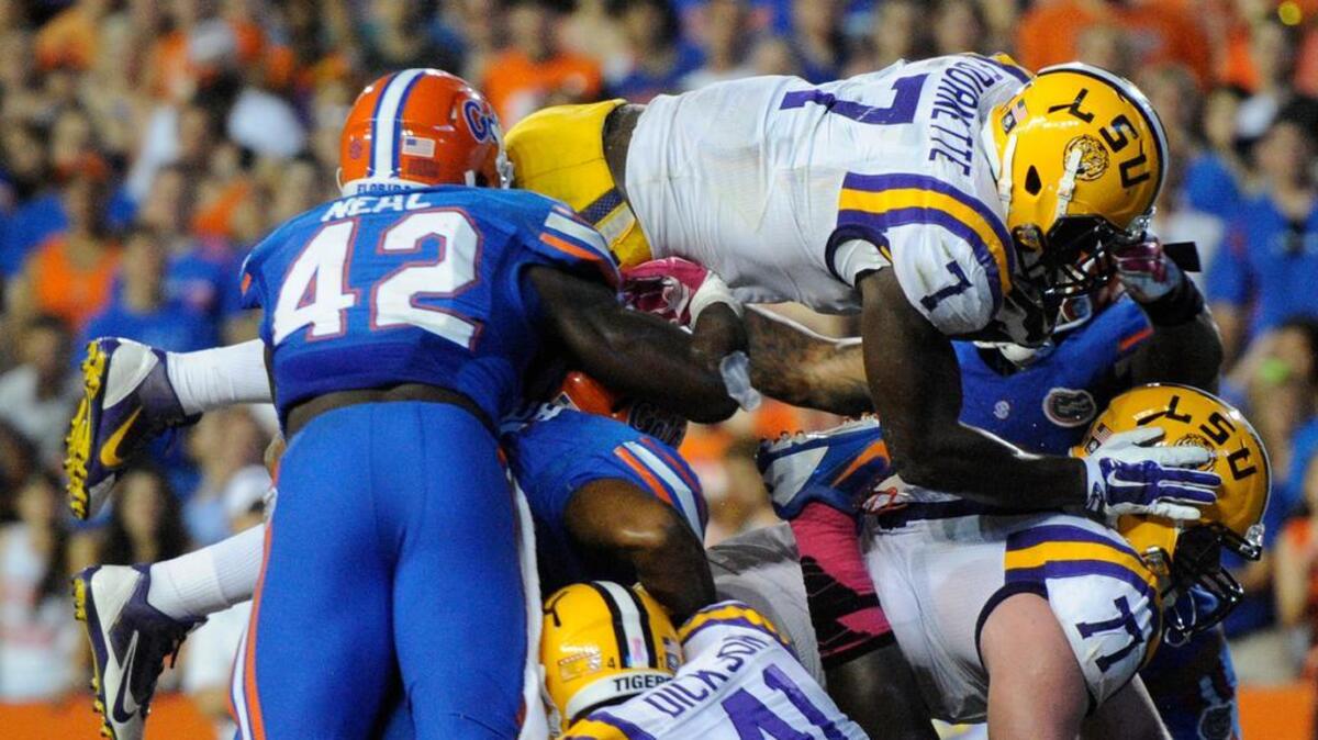 
LSU’s Leonard Fournette dives over the Florida defense for a touchdown last year. Saturday, Forunette and the Tigers face Florida in a battle of unbeatens.

