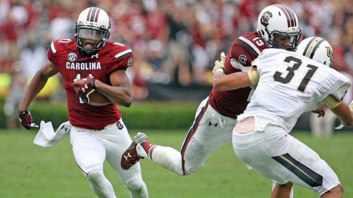 
South Carolina quarterback Lorenzo Nunez, right, blocks for receiver Pharoh Cooper on Saturday during Cooper’s touchdown run.
