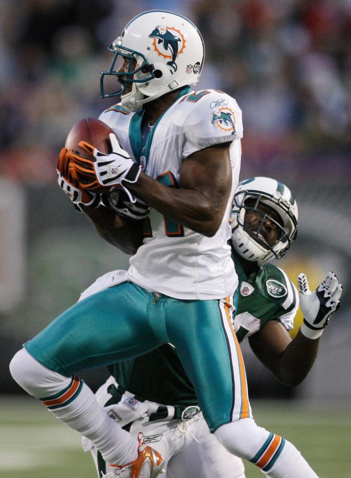 Andre Goodman (21) intercepts a pass intended for New York Jets' Leon Washington when he was playing for the Miami Dolphins in 2008.
