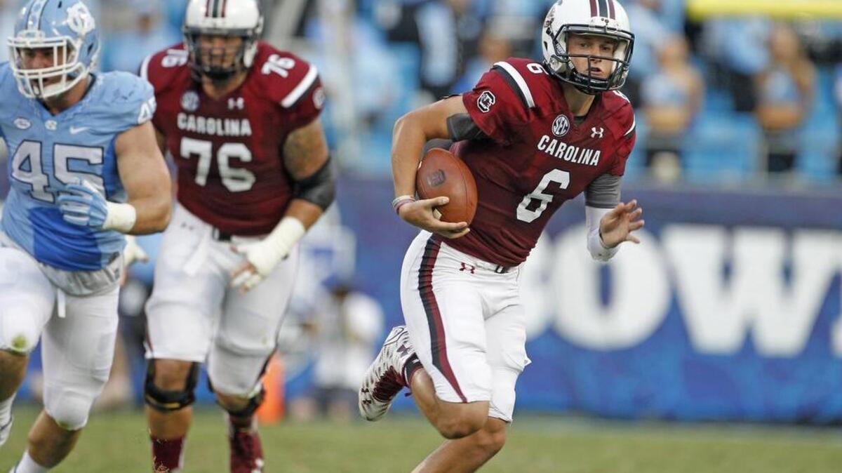 
USC quarterback Connor Mitch (6) looks to run in the first half of the Belk College Kickoff in Charlotte, NC, Thursday.
