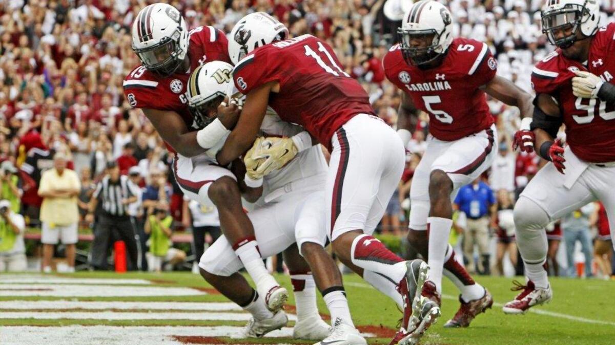 
South Carolina Gamecocks defensive end Boosie Whitlow (49) and South Carolina Gamecocks linebacker T.J. Holloman (11) bring down UCF's Taj McGowan for a safety in the first half at Williams-Brice Stadium in Columbia, SC, Saturday, September 26, 2015.
