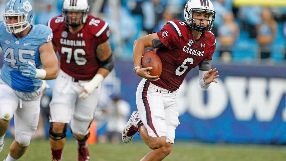 
USC quarterback Connor Mitch looks to run in the first half of the Belk College Kickoff in Charlotte.
