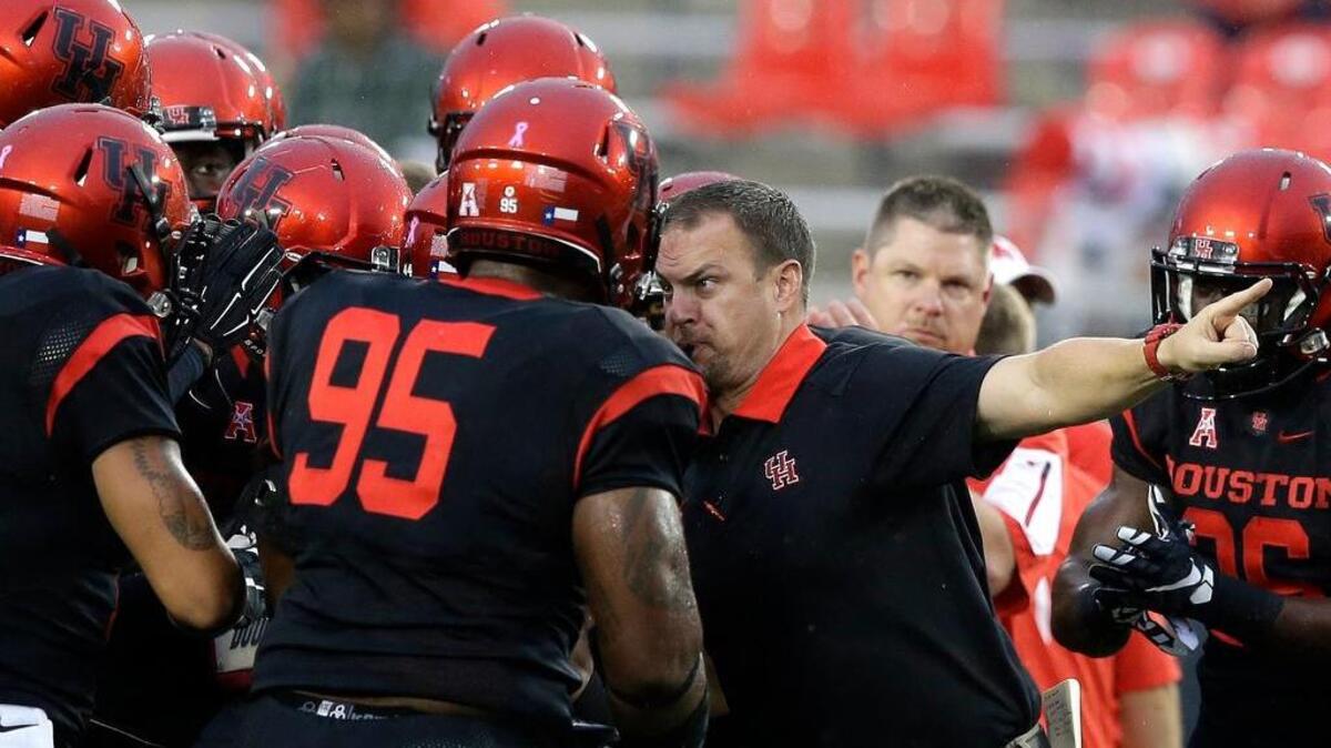 Houston coach Tom Herman, right, is expected to get in the face of players on another team next season when he, and Memphis’ Justin Fuente are hired at bigger schools.