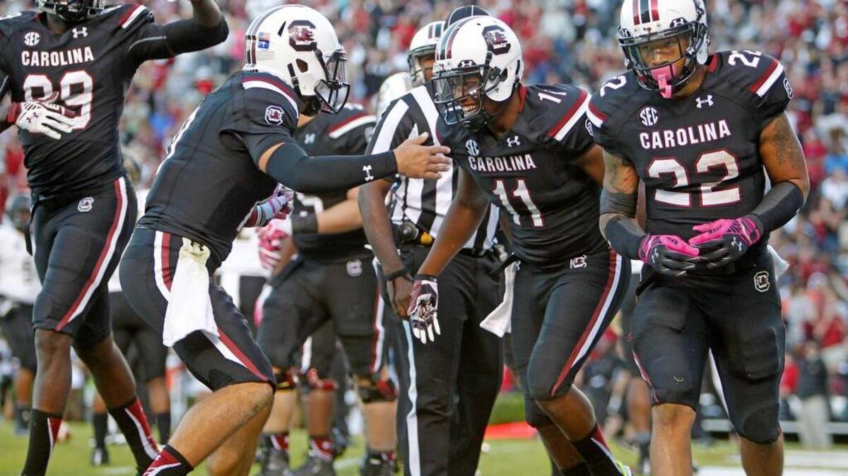 
South Carolina Gamecocks quarterback Perry Orth (10) celebrates Saturday with wide receiver Pharoh Cooper (11) after his touchdown catch.
