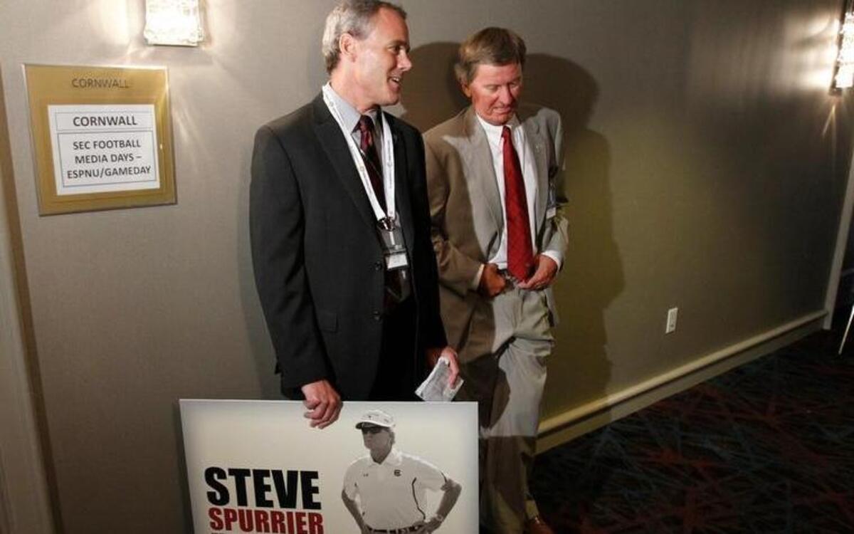 
South Carolina head football coach Steve Spurrier waits for Jadeveon Clowney to finish his interview during SEC football media days in 2013.
