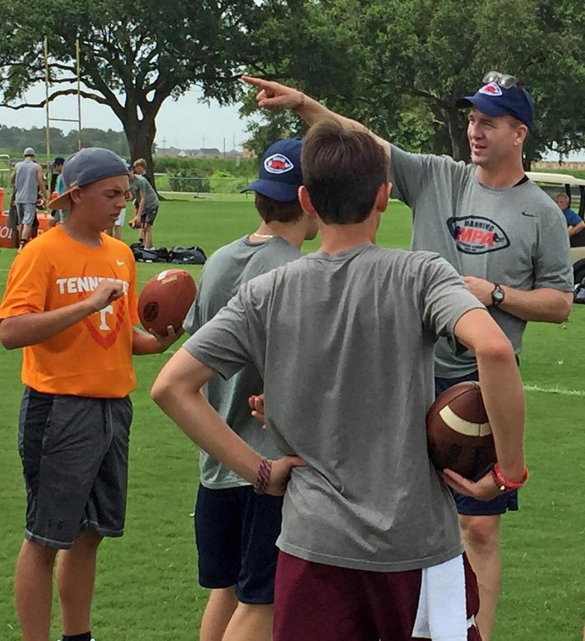 Peyton Manning leads campers on Friday at the Manning Passing Academy