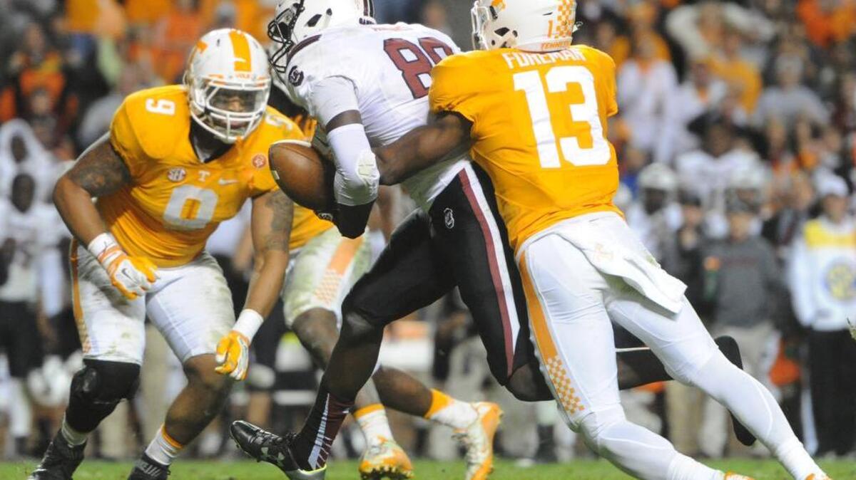 Tennessee defensive back Malik Foreman (13) forces a fumble by South Carolina tight end Jerell Adams (89) to clinch Tennessee's 27-24 win at an NCAA college football game in Knoxville, Tenn. on Saturday, Nov. 7, 2015. (Adam Lau/Knoxville News Sentinel via AP)