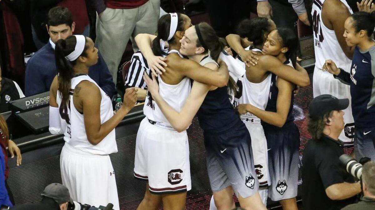 A'ja Wilson and Breanna Stewart hug after Monday night's game between the South Carolina Gamecocks and Conneticut Huskies.