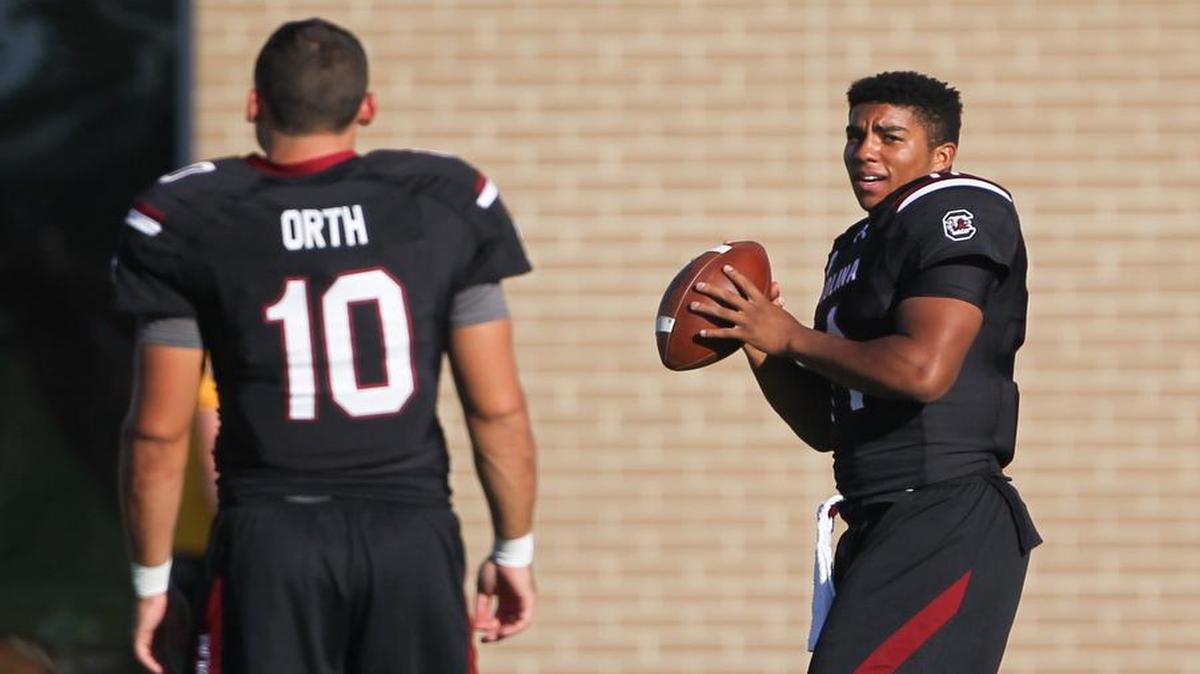 Quarterbacks Perry Orth (10) and Brandon McIlwain (11) warm up during USC football practice at the South Carolina practice facility Tuesday.