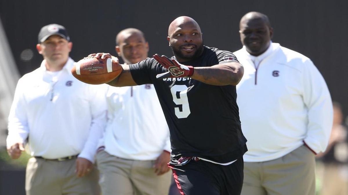 Former quarterback Corey Jenkins throws a pass while playing in the alumni football game prior to the Garnet and Black spring football game at Williams-Brice Stadium.