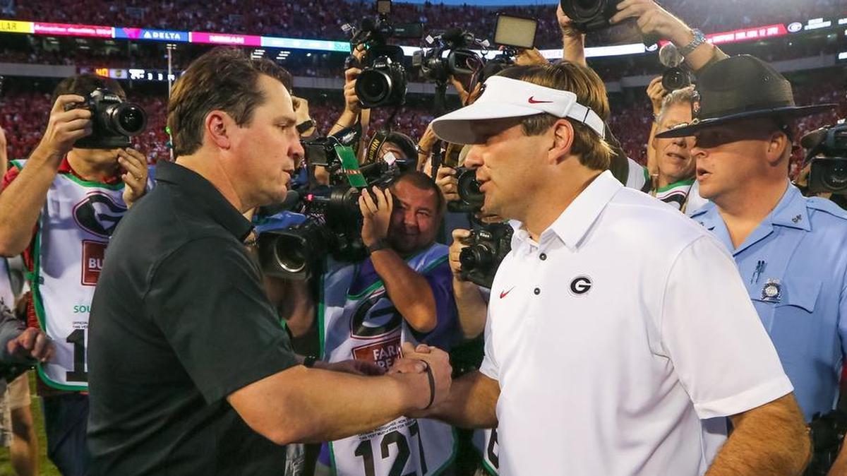 South Carolina head coach Will Muschamp and Georgia Bulldogs head coach Kirby Smart meet at midfield after Georgia defeated South Carolina 24-10.