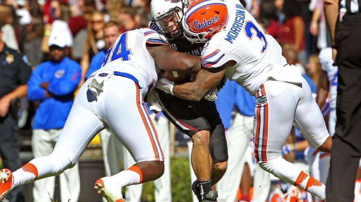 South Carolina quarterback Perry Orth is stopped on a keeper by Florida linebacker Antonio Morrison (3) in the first half of the Gamecocks’ 24-14 loss.