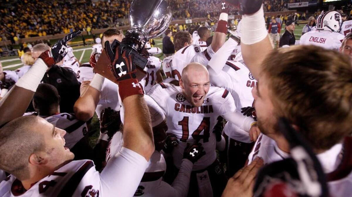 
In 2013, South Carolina quarterback Connor Shaw (14) celebrates with teammates after their overtime win over Missouri at Faurot Field. 
