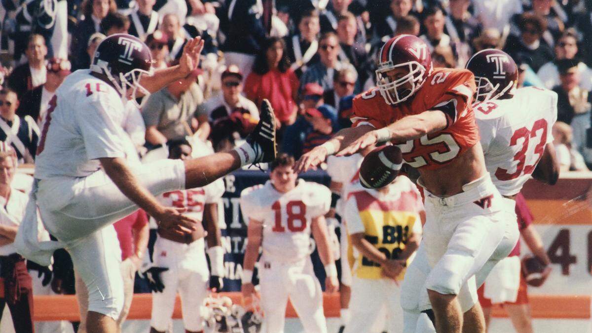 Virginia Tech’s William Ferrell (right) blocks a punt against Temple during the 1994 season.