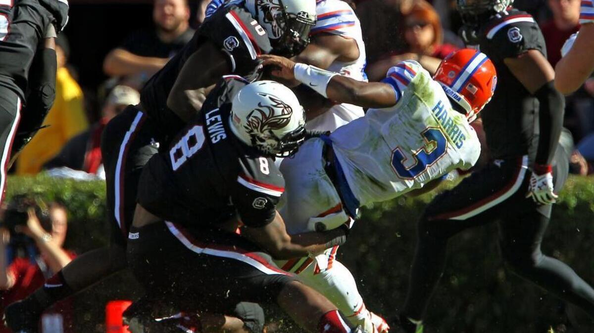 South Carolina defensive end Marquavius Lewis brings down Florida quarterback Treon Harris on Saturday. Lewis and the Gamecocks defense will have a tough test against The Citadel and its triple option offense this week.