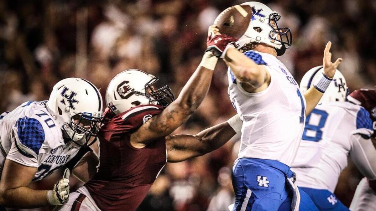 
USC defensive end Marquavius Lewis makes a play on Kentucky quarterback Patrick Towles.
