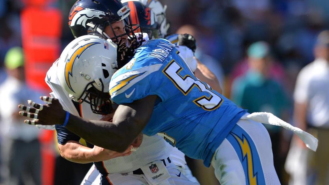 Denver Broncos quarterback Trevor Siemian (13) is hit by Los Angeles Chargers outside linebacker Melvin Ingram (54) during the second quarter at StubHub Center.