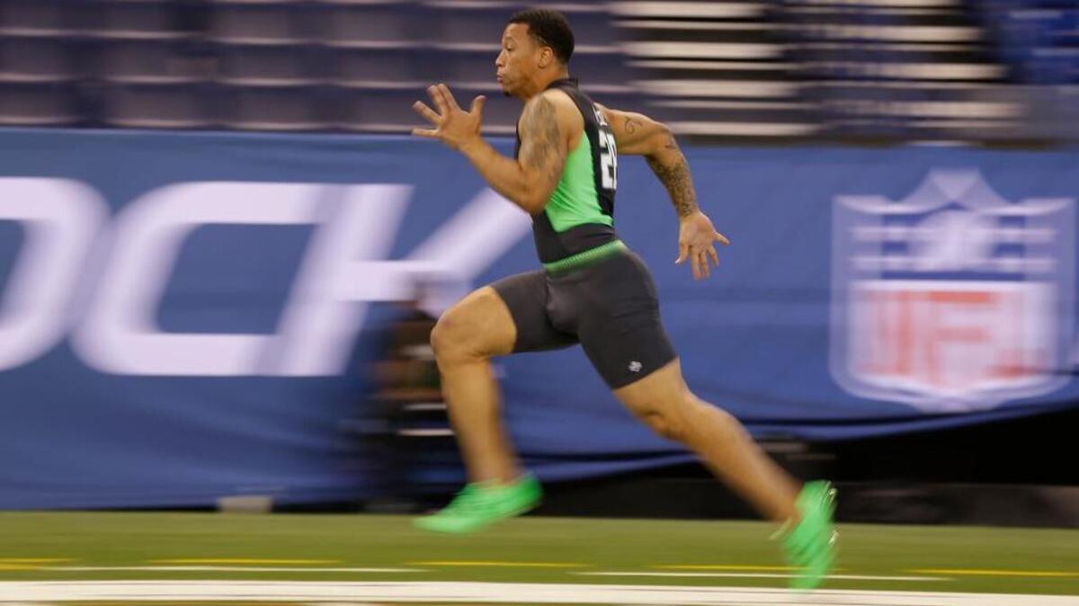 In this image taken with a slow shutter speed, South Carolina running back Brandon Wilds runs the 40-yard dash at the NFL football scouting combine in Indianapolis, Friday, Feb. 26, 2016.