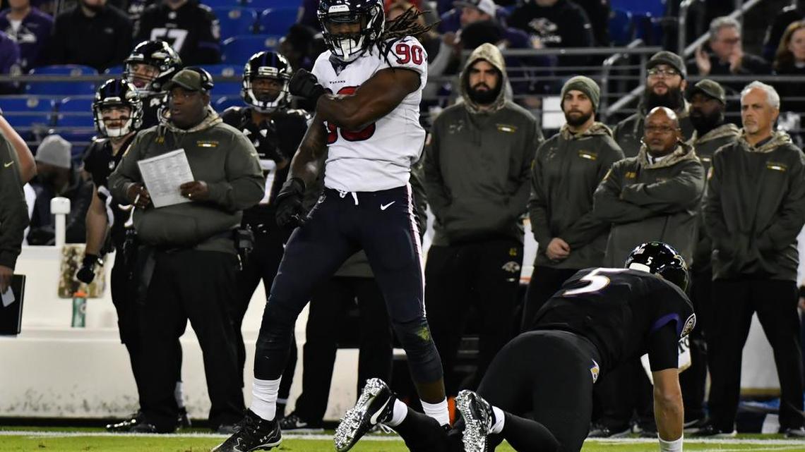 Houston Texans defensive end Jadeveon Clowney (90) reacts after hitting Baltimore Ravens quarterback Joe Flacco (5) on third down during the first quarter at M&T Bank Stadium.