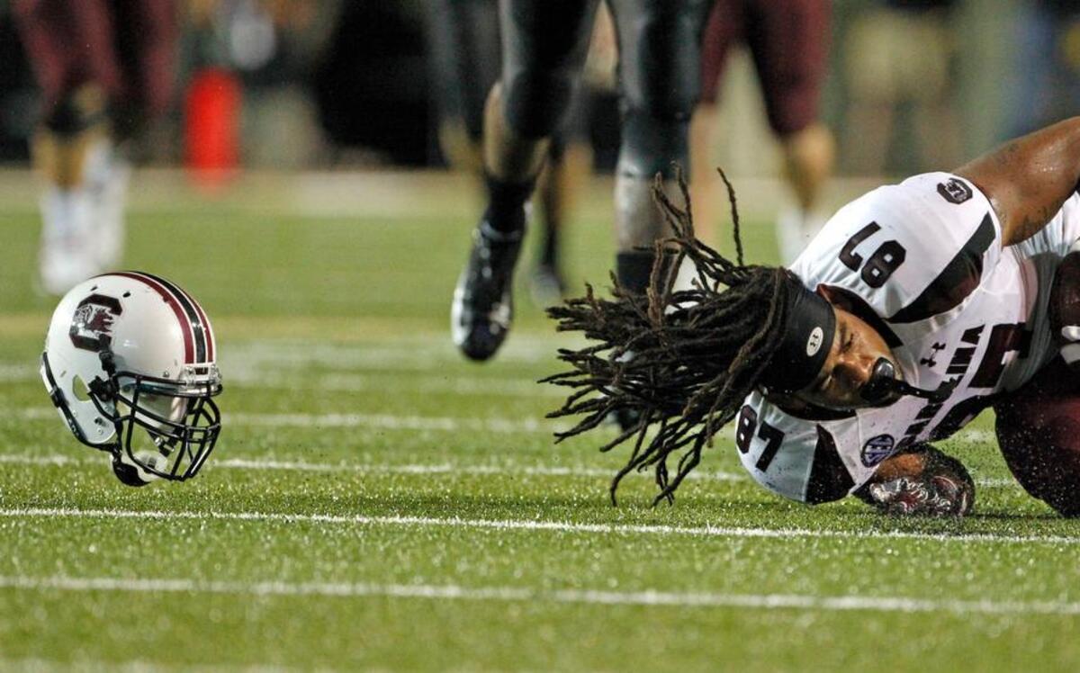 South Carolina tight end Justice Cunningham (87) holds on to the ball after a hit that knocks his helmet off in the fourth quarter of the Gamecocks’ 2012 game against the Commodores at Vanderbilt Stadium.