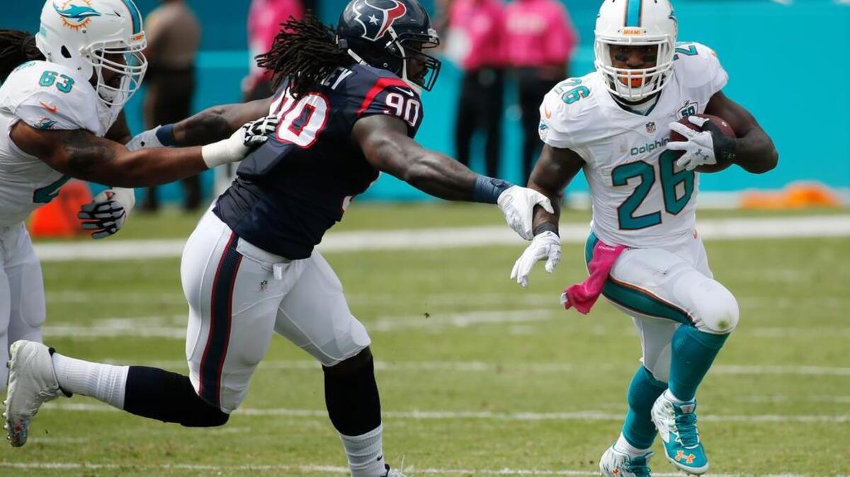 Houston outside linebacker Jadeveon Clowney tries to bring down Miami’s Lamar Miller earlier this season. Clowney, the 2014 No. 1 pick, still feels like a rookie from all the time he has missed because of injury.