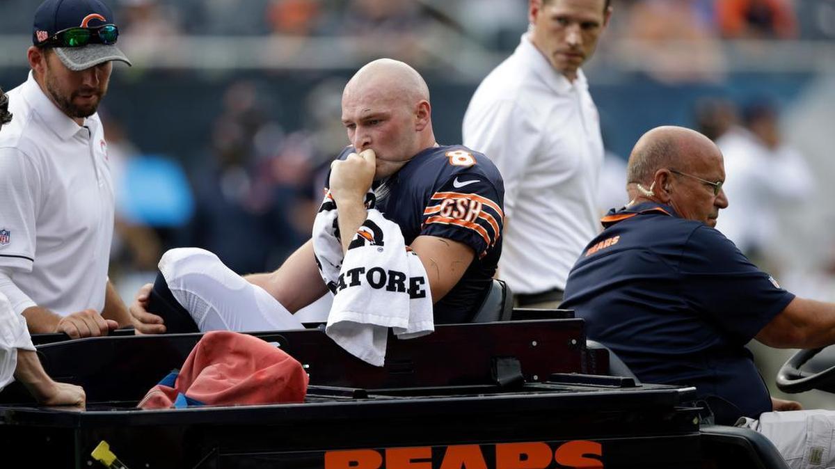 Chicago Bears quarterback Connor Shaw (8) is escorted off the field after getting hurt on a play during the second half of an NFL preseason football game against the Kansas City Chiefs, Saturday, Aug. 27, 2016, in Chicago. The Chiefs won 23-7.