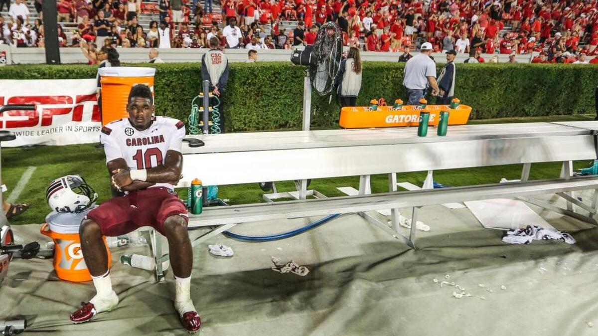 
South Carolina linebacker Skai Moore sits alone after Saturday’s loss to Georgia at Sanford Stadium.
