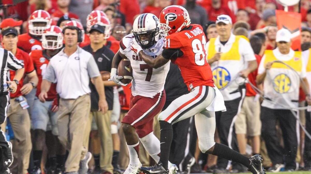 
South Carolina running back Shon Carson tries to pull away from a Georgia defender Saturday.
