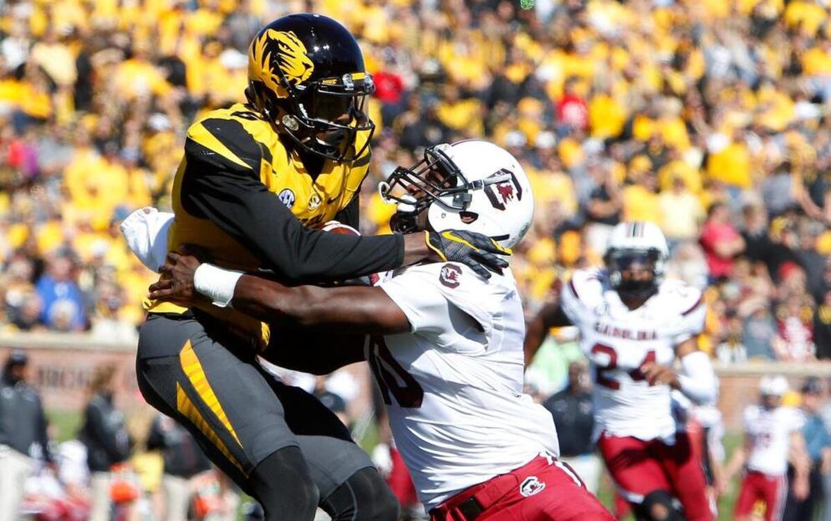 
Missouri’s Marquise Doherty is brought down by South Carolina linebacker Skai Moore in the first half in Columbia, Mo., on Saturday.
