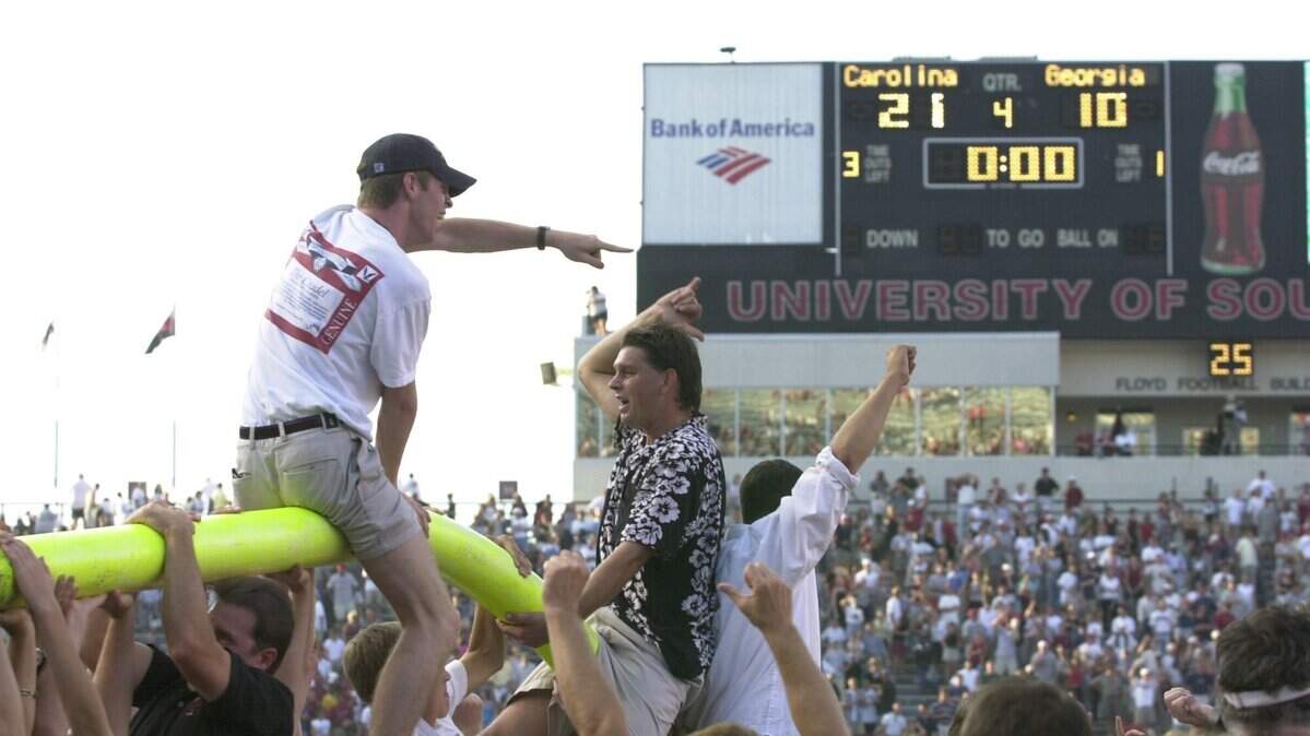 Gamecock fans hang off what's left of the goal posts after South Carolina's upset victory over Georgia in the 2000 season.