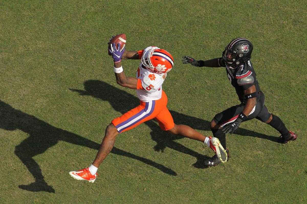 Clemson wide receiver Tee Higgins (5) catches a touchdown pass in front of South Carolina defensive back Jammie Robinson (7) during first-quarter action in Columbia, S.C. on Saturday, Nov. 30, 2019. (Travis Bell/SIDELINE CAROLINA)