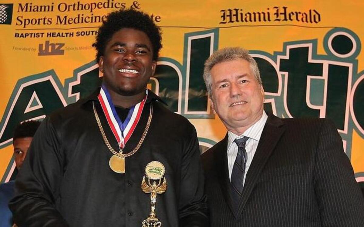 Former Central High football player and current South Carolina Gamecocks freshman Keir Thomas accepts his 8A-6A Defensive Player of the Year award from Miami Herald writer Bill Daley at the Miami Herald's All-Dade athletic awards banquet on Thursday.