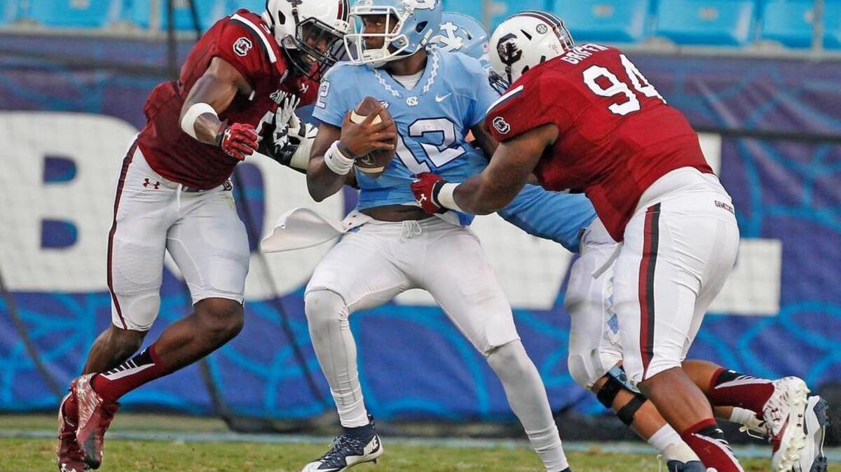 
USC defensive tackle Kelsey Griffin (94) brings down UNC quarterback Marquise Williams (12) in the first half of the Belk College Kickoff in Charlotte, NC, Thursday, September 3, 2015.
